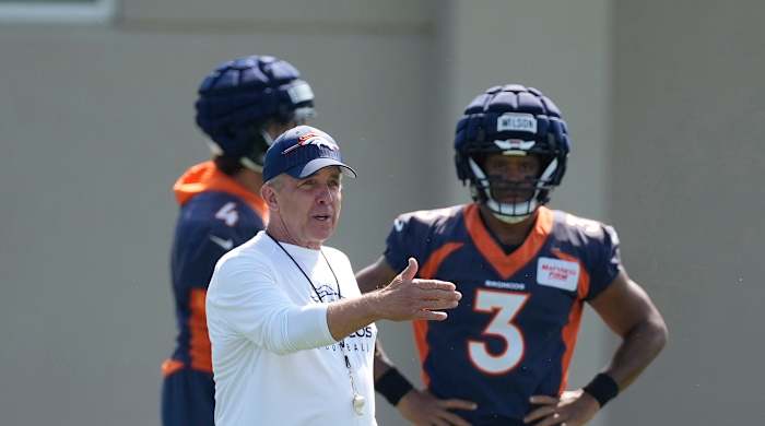 Broncos coach Sean Payton, front left, directs players as quarterback Russell Wilson (3) looks on.